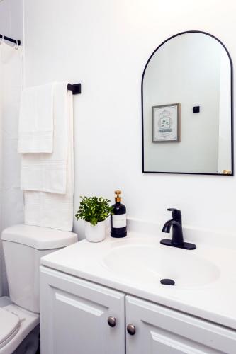 a bathroom with a white sink and a mirror at Metropolitan Splendor in Fort Washington