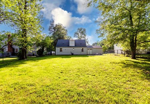 a white barn with a large grassy yard at Metropolitan Splendor in Fort Washington