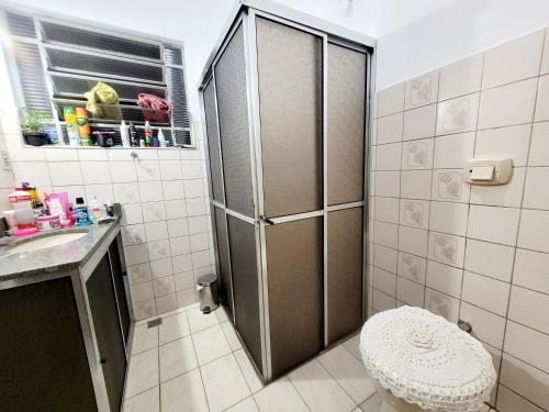 a bathroom with a shower with a toilet and a sink at Quarto Proença in Campinas