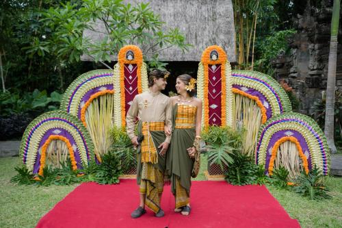 a man and a woman standing on a red carpet at The Artini Dijiwa Ubud in Ubud