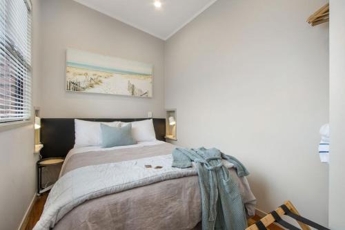 a bedroom with a large bed in a room at Te Mahana Coastal Retreat in Waihi Beach