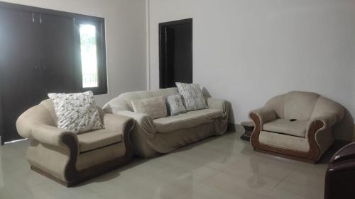 a living room with a couch and a chair at Vosu Homestay in Dimāpur