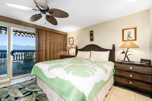 a bedroom with a bed and a balcony at Memories await @ remodeled Ks e8 - Sullivan in Kahana