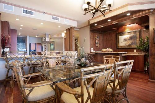 a dining room with a glass table and chairs at Oceanfront corner unit w/ ac! sk215- Sullivan in Kahana