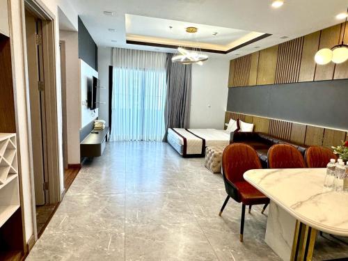 a hotel room with a bed and a table and chairs at FLC Sea Tower Quy Nhơn__Du Lịch Bình Định in Quy Nhon