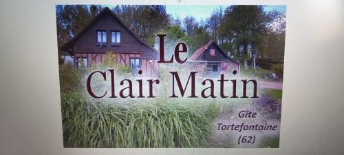 a book with a picture of a house at Le Clair Matin in Tortefontaine