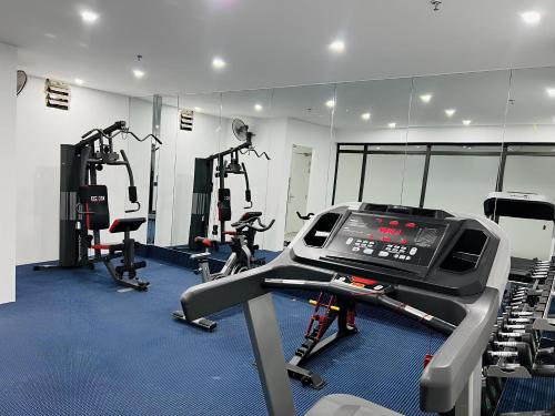 a gym with a treadmill and several tread machines at MAY DE VILLE Crown Hotel in Hanoi
