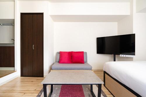 a bedroom with a bed and a red pillow at Best Residence Kujo in Osaka