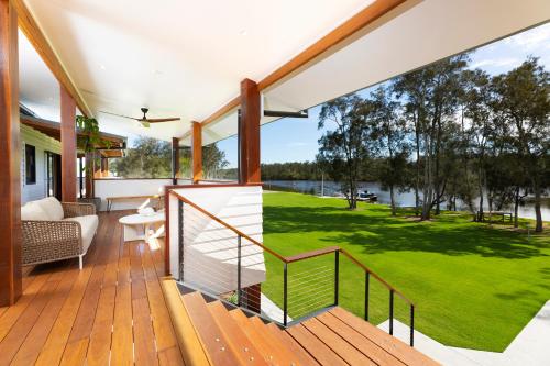 a house with a deck with a view of a yard at Neat Acres Farmhouse in Darawank