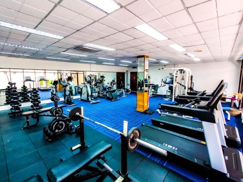 a gym with several treadmills and machines at Holiday Villa Resort & Beachclub Langkawi in Pantai Cenang