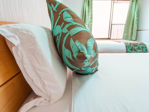 a pillow sitting on top of a bed with a window at 鯉 in Osaka