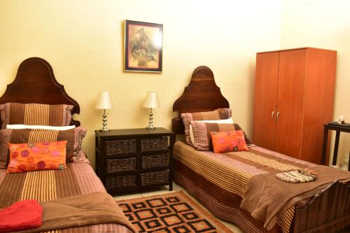 a bedroom with two beds and a dresser at kestell Hotel in Kestell