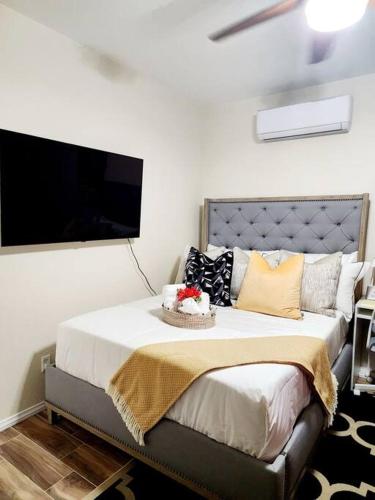 a bedroom with a bed with a tv on the wall at Beautiful All Private GuestSuite in Lancaster