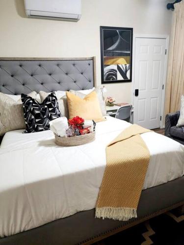 a large white bed with a basket of flowers on it at Beautiful All Private GuestSuite in Lancaster