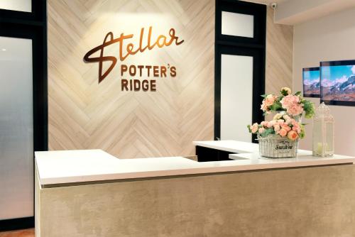a store with a sign on a wall with flowers on a counter at Stellar Potter's Ridge in Laurel
