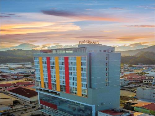 a building with a red and yellow stripe on it at Horison Ultima Entrop Papua in Jayapura