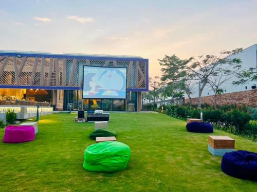 a large building with a screen in the grass at TTC Van Phong Bay Resort - Himalaya Sauna & Steam Retreat Included in Ninh Hòa