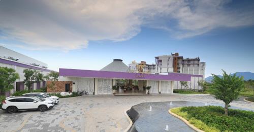 a building with cars parked in a parking lot at TTC Van Phong Bay Resort - Himalaya Sauna & Steam Retreat Included in Ninh Hòa