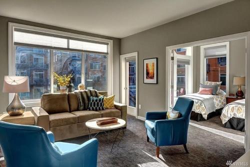 un soggiorno con un divano e un letto di DT Designer's 2BR Condo Parking Tub Pool - 99 walk score a Seattle