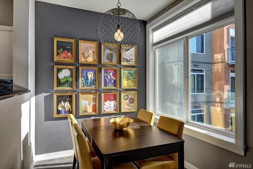 a dining room with a table and chairs and a window at DT Designer's 2BR Condo Parking Tub Pool - 99 walk score in Seattle