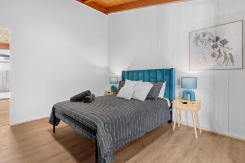 Schlafzimmer mit einem Bett und einem Beistelltisch in der Unterkunft Recharge in Waurn Ponds in Geelong