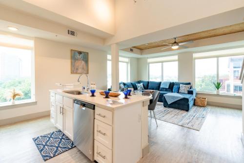 an open kitchen and living room with a couch at RiverWalk PentHouse Oasis w/Free Parking Gym Pool in San Antonio