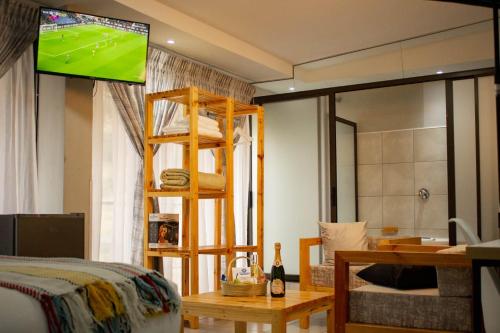 a bedroom with a bunk bed with a television on the wall at Thabeng Hotel & Restaurant in Maseru