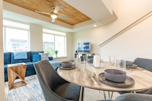 a living room with a table with chairs and a couch at RiverWalk PentHouse Oasis w/Free Parking Gym Pool in San Antonio