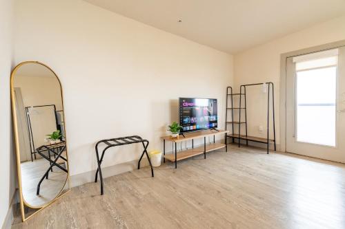 a dressing room with a mirror and a tv at RiverWalk PentHouse Oasis w/Free Parking Gym Pool in San Antonio