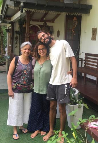 a man and two women standing in front of a house at Villa25 Homestay free pick up from the centre in Kandy