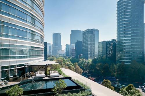 a building with a swimming pool and a city at The St. Regis Mexico City in Mexico City