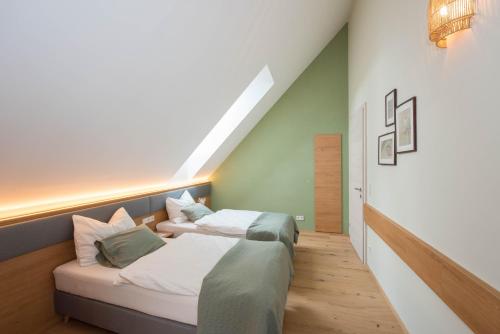a bedroom with two beds and a couch at Naturparkbauernhof Pöltl in Pöllau