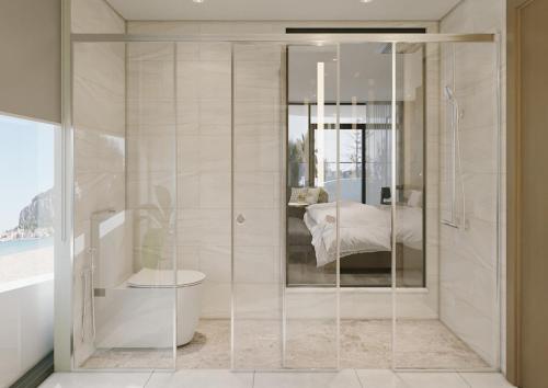 y baño con ducha y puerta de cristal. en Adamas Boutique Hotel Nha Trang en Nha Trang