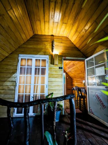 a cabin with a wooden ceiling and a window at The Emerald Guest House & Villa in Unawatuna