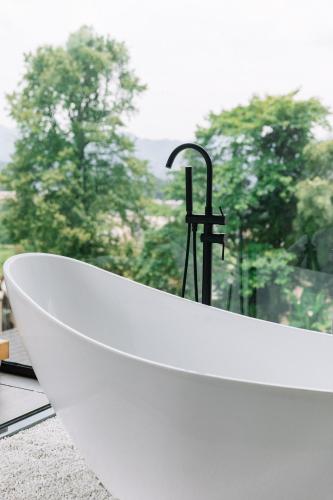 a bath tub sitting in front of a window at Avatar Mountain Resort in Zhangjiajie