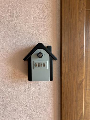 a lightswitch on a wall with a house on it at Manti in Skala Marion
