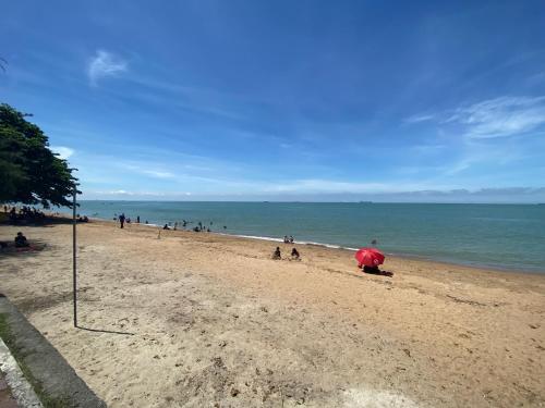 a group of people on a beach with the ocean at LeThuHouse in Melaka