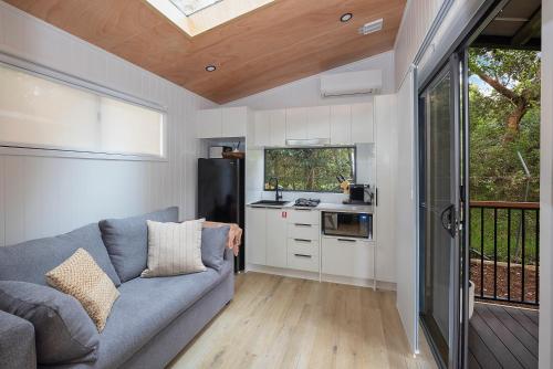 a living room with a couch and a kitchen at Reflections North Haven - Holiday Park in North Haven