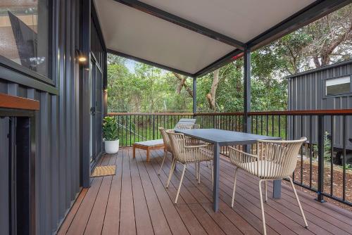 a patio with a table and chairs on a deck at Reflections North Haven - Holiday Park in North Haven