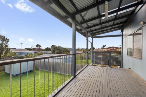 an outdoor deck with a view of a yard at Just Beachy in Indented Head