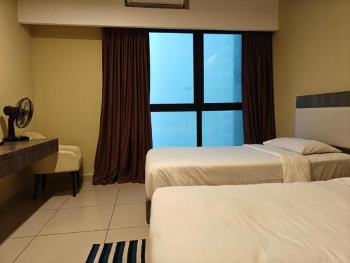 a hotel room with two beds and a window at Grand Ion Delemen by 91 Homestay in Genting Highlands