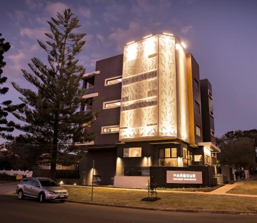 a building with a car parked in front of it at The Arbour Boutique Apartments in Toowoomba