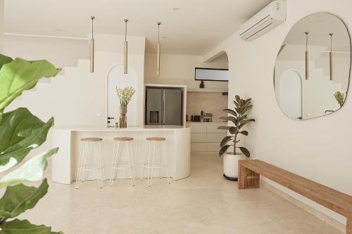 a kitchen with a island with bar stools at Casa Mona - Luxury 3 Bedroom Villa in Bingin in Uluwatu