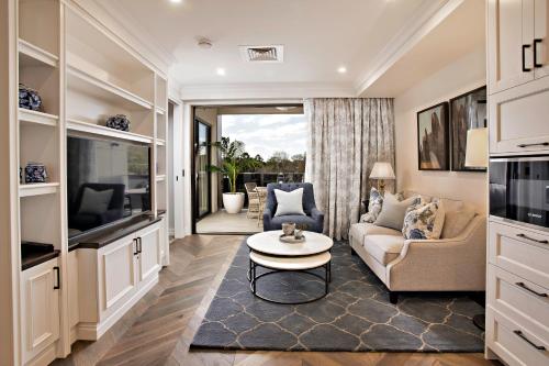 a living room with a couch and a table at The Arbour Boutique Apartments in Toowoomba