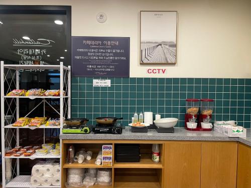 a bakery with a counter with food on it at Calton Hill Hotel in Jeonju
