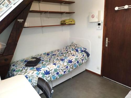 une petite chambre avec un lit dans une pièce dans l'établissement La studette de Vesle, à Reims