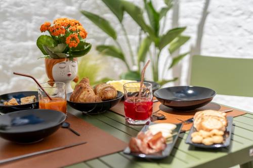 a table with plates of food on a table at Naiira Luxury Trullo - jacuzzi and patio in Alberobello