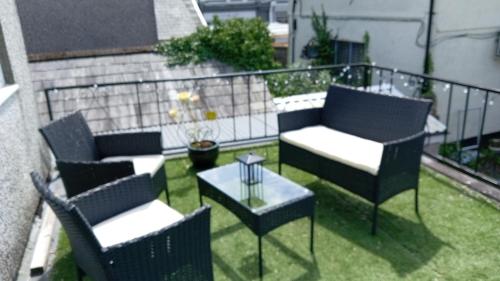 a patio with two chairs and a table on a balcony at Large 2 Bed Holiday Let in Central Ystradgynlais in Ystradgynlais
