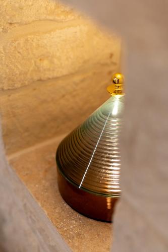 a coil of metal sitting on top of a ledge at Naiira Luxury Trullo - jacuzzi and patio in Alberobello
