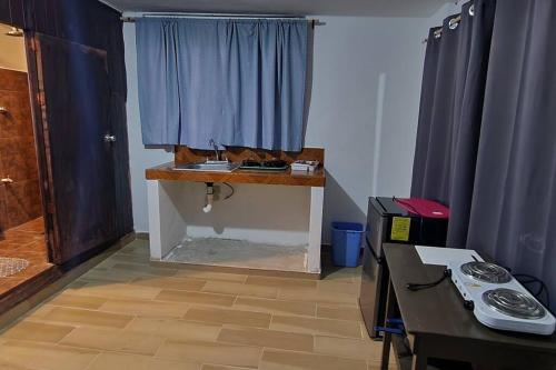 a room with a table and a blue curtain at Departamento privado, amplio, Chetumal, Q. Roo in Chetumal